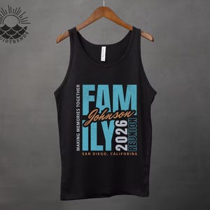 May include: Black vest top with the words "FAMILY Johnson 2026 REUNION" in teal and orange. The text "MAKING MEMORIES TOGETHER" and "SAN DIEGO, CALIFORNIA" are also printed on the shirt. The vest top is hanging on a wooden hanger.
