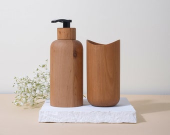 Bathroom set with a dispenser and a cup for toothbrushes