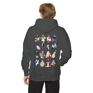 May include: A dark gray hooded sweatshirt with a colorful graphic print of 16 people with their dogs. The graphic print features a variety of people with different hairstyles, clothing, and dog breeds.