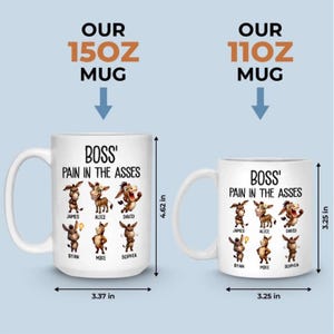 May include: Two white ceramic mugs with the text "BOSS' PAIN IN THE ASSES" and cartoon donkey illustrations. The larger mug is 4.62 inches tall and 3.37 inches wide, while the smaller mug is 3.25 inches in both dimensions. The mugs are labeled "OUR 15OZ MUG" and "OUR 11OZ MUG".
