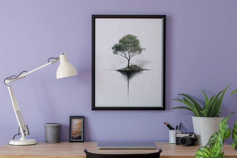 May include: A black framed print of a watercolor painting of a tree growing out of a small island. The tree is green and the island is brown. The background is white with a few black dots.