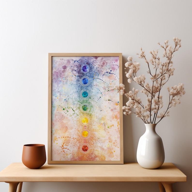 May include: A framed watercolor painting of the seven chakras, depicted as colorful circles arranged vertically on a white background with intricate details and a light purple, blue, and orange watercolor wash.