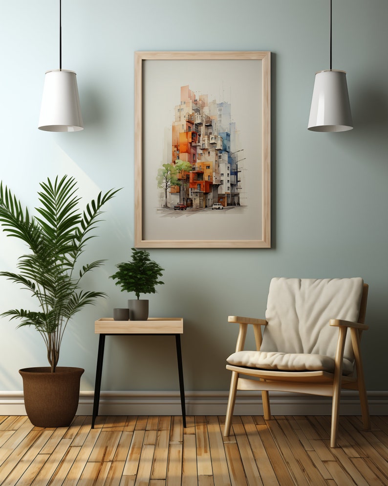 May include: A framed watercolor print of a colorful cityscape hangs on a light green wall. The artwork features buildings in shades of orange, blue, and white. A wooden chair, a small table with plants, and a potted palm tree are in the foreground.