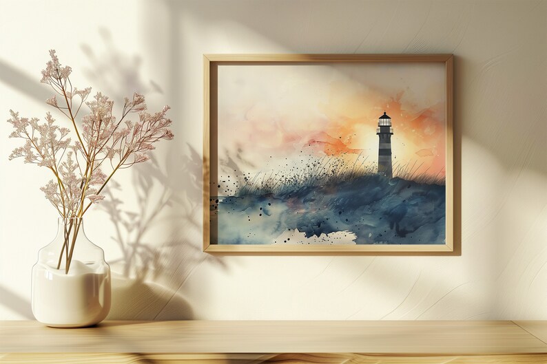 Puede incluir: Una pintura de acuarela de un faro en una costa rocosa al atardecer. El cielo es una mezcla de naranja, rosa y azul, y el agua es de un azul profundo. El faro est&aacute; silueteado contra el cielo.