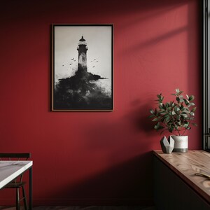 Puede incluir: Una impresi&oacute;n enmarcada en blanco y negro de un faro en una isla rocosa con p&aacute;jaros volando por encima. La impresi&oacute;n est&aacute; colgada en una pared roja en una cocina moderna.