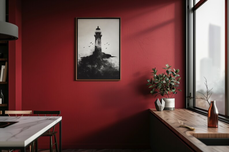 Puede incluir: Una impresi&oacute;n enmarcada en blanco y negro de un faro en una isla rocosa con p&aacute;jaros volando por encima. La impresi&oacute;n est&aacute; colgada en una pared roja en una cocina moderna.