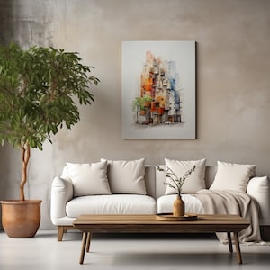 May include: A living room scene featuring a white sofa with cream-colored pillows, a wooden coffee table, and a large potted tree. A colorful abstract painting hangs on the wall. The room has a neutral color palette.
