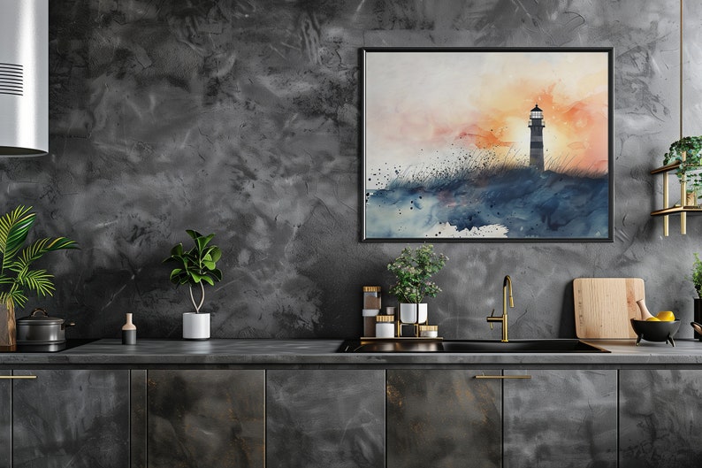 Puede incluir: Una pintura de acuarela de un faro en una costa rocosa con una puesta de sol en el fondo. La pintura est&aacute; enmarcada en negro y colgada en una pared gris en una cocina.