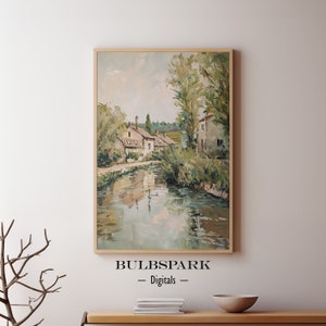 May include: A painting of a quaint village scene with houses along a river. The houses are painted in shades of beige and brown, with green trees and foliage surrounding them. The river is a calm blue-green, reflecting the sky and trees. The painting is done in a loose, impressionistic style, with visible brushstrokes.
