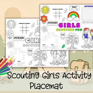 May include: Two activity placemats with the text "Girls Scouting Fun" and "Scouting Girls Activity Placemat". The placemats feature illustrations of a sun, flower, butterfly, rainbow, owl, tree, and two girls. A set of colored pencils and a backpack are also visible.