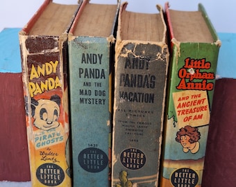 May include: Four vintage "Better Little Book" comic books. Titles include "Andy Panda Pirate Ghosts", "Andy Panda and the Mad Dog Mystery", "Andy Panda's Vacation", and "Little Orphan Annie and the Ancient Treasure of Am". The books have worn covers and aged pages.