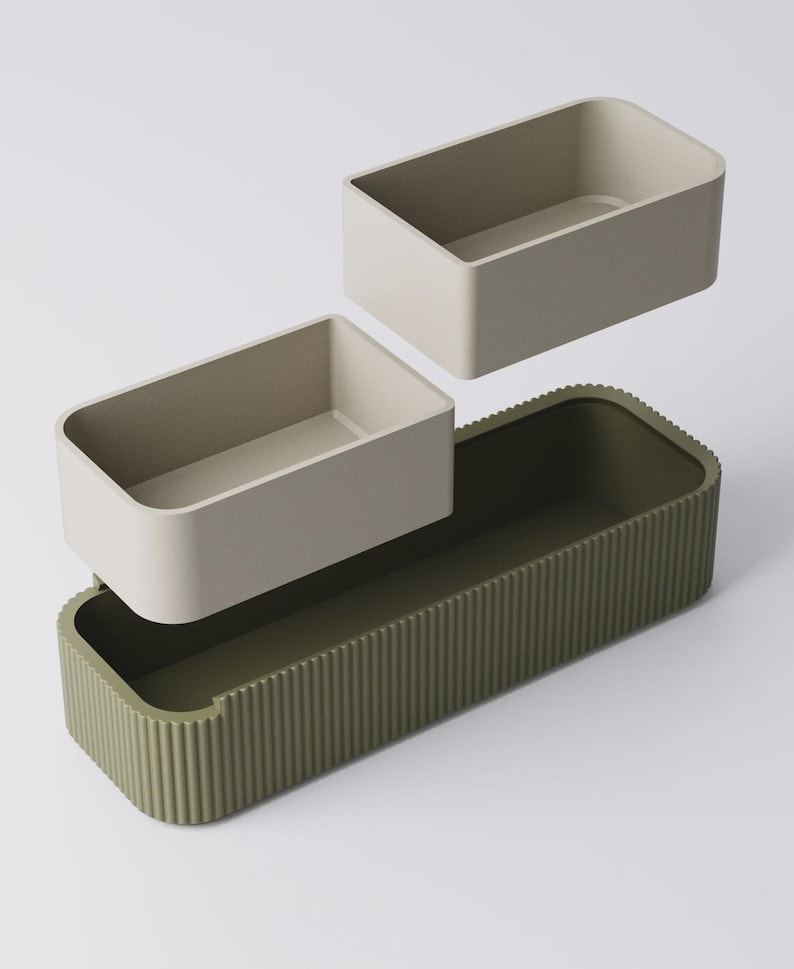 Peut inclure: Ensemble de r&eacute;cipients rectangulaires vert olive et beige. Le r&eacute;cipient de base a un ext&eacute;rieur nervur&eacute;, tandis que les deux petits r&eacute;cipients sont beiges. Les r&eacute;cipients sont con&ccedil;us pour s'embo&icirc;ter.