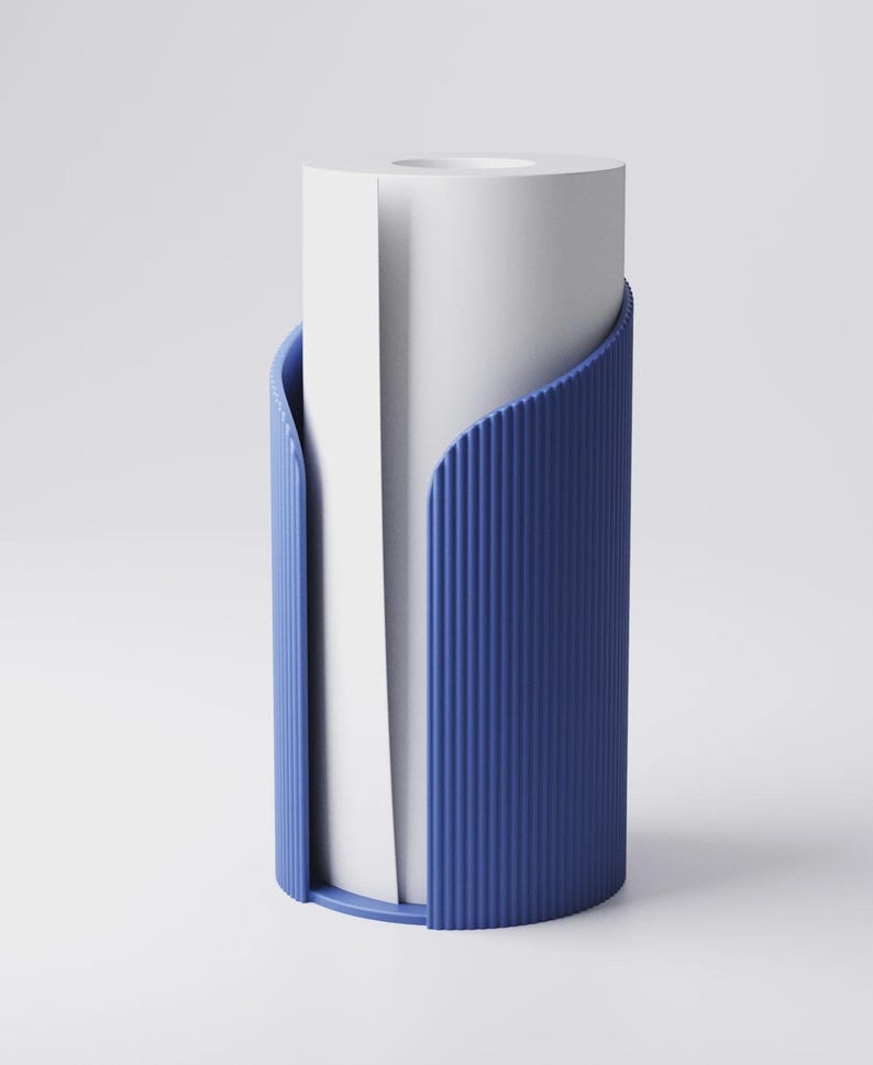 May include: A modern blue paper towel holder with a ribbed texture. The holder has a curved design that cradles a roll of white paper towels, creating a clean and minimalist aesthetic.
