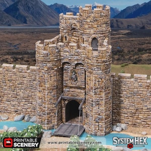 May include: A detailed model of a castle gatehouse with a working drawbridge. The structure is made of textured stone blocks in shades of tan and brown. The scene includes a small river and the text "Printable Scenery" and "System Hex".