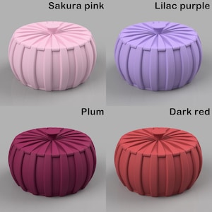 May include: Four decorative, round ottomans in various colors: Sakura pink, lilac purple, plum, and dark red. Each ottoman has a ribbed, pleated design and a small, round top. The text labels each color.
