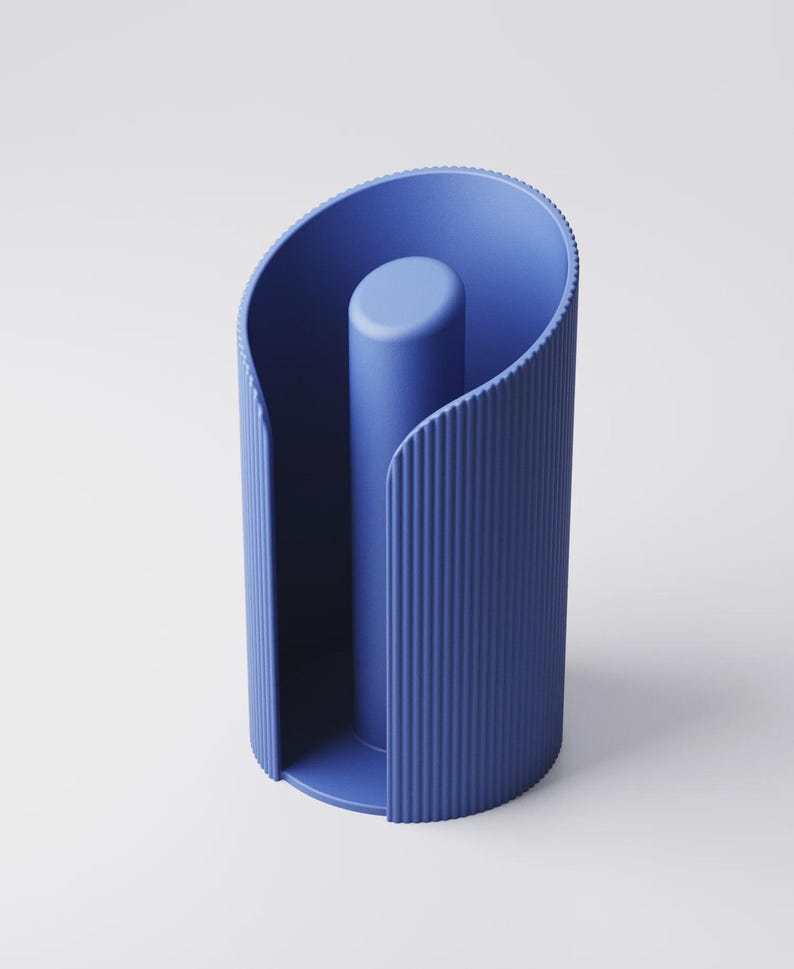 May include: A modern, blue paper towel holder. The holder has a cylindrical shape with vertical ribbed detailing and a central post. The design features a curved top and base, creating a sleek, minimalist aesthetic.