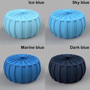 May include: Four round, ribbed ottomans in varying shades of blue: ice blue, sky blue, marine blue, and dark blue. Each ottoman has a circular top and a pleated, cylindrical body. The text labels each ottoman's color.
