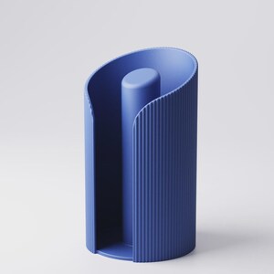 May include: A modern, blue paper towel holder. The holder has a cylindrical shape with vertical ribbed detailing on the exterior. A central, solid post rises from the base. The design is minimalist and contemporary.