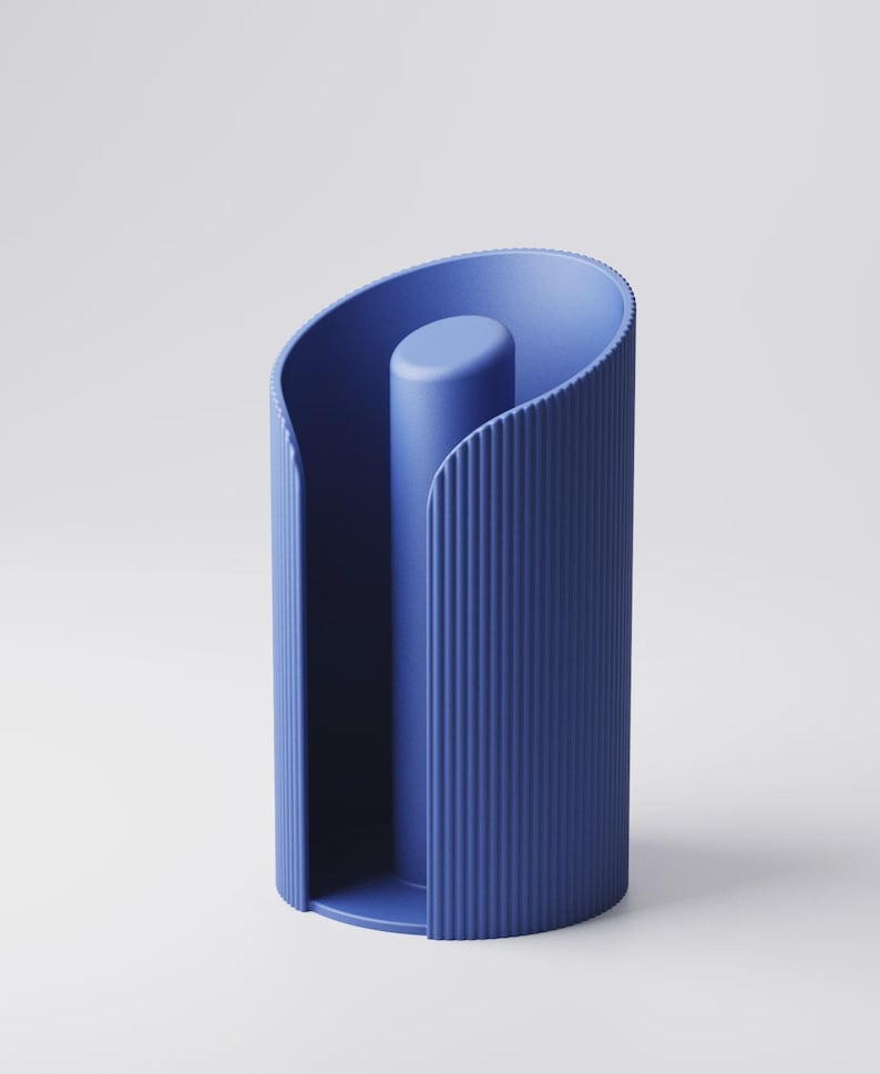 May include: A modern, blue paper towel holder. The holder has a cylindrical shape with vertical ribbed detailing on the exterior. A central, solid post rises from the base. The design is minimalist and contemporary.