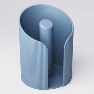 May include: A blue paper towel holder with a vertical central post. The holder has a curved, open design with vertical ridged detailing on the sides. The holder is made of a solid, matte material.