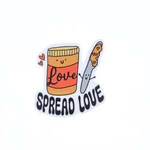 May include: A sticker with a cartoon peanut butter jar and knife. The jar has a smiling face and the text "Love" on it. The knife has a smiling face and peanut butter on it. The text "Spread Love" is below the jar and knife.