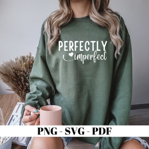 May include: A green sweatshirt with the text "PERFECTLY imperfect" in white with a small heart symbol.