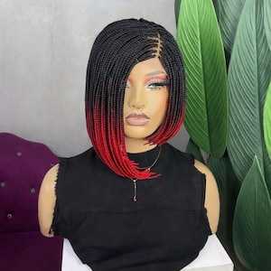 May include: A handmade wooden sign with the text "Welcome to our home" in a handwritten style. The sign is painted white with a dark stained frame. A small green plant is placed on the sign.