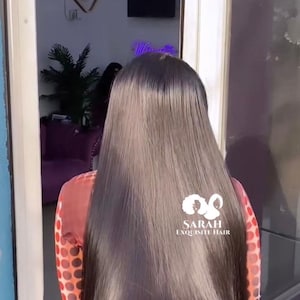 May include: A woman with long, straight, black hair wearing a red and white polka dot shirt. The logo for Sarah Exquisite Hair is visible in the lower right corner of the image.