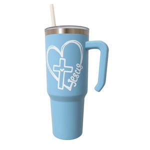 May include: A light blue tumbler with a handle and a straw. The tumbler features a white heart and cross design with the word "Jesus" written in script. The tumbler is designed to hold cold beverages.
