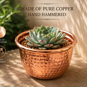 May include: A round, hand-hammered copper planter containing a green succulent plant. The text MADE OF PURE COPPER HAND HAMMERED is visible above the planter, with additional icons and text labels confirming the material and construction method.