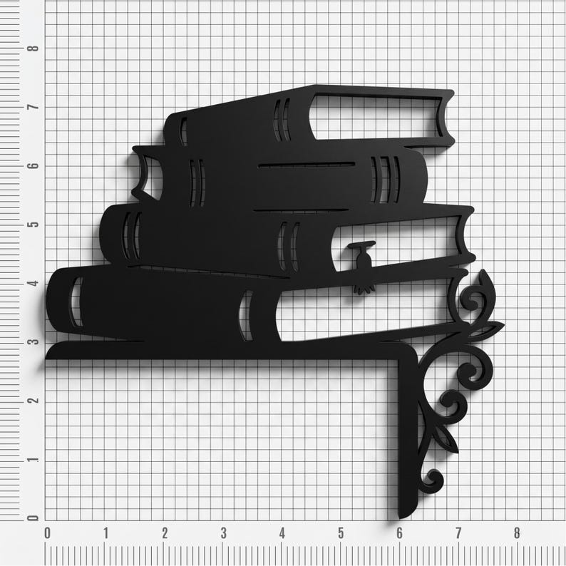 May include: A black metal corner shelf bracket featuring a stack of four books with a decorative scrollwork design on the right side. The object is positioned against a grid background with measurements in inches, showing a width of 6 inches.