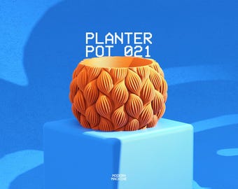 May include: An orange planter pot with a repeating textured pattern of vertical, leaf-like ridges covering the exterior. The text PLANTER POT 021 is displayed in white pixelated font above the object, with MODERN MACHINE at the bottom.