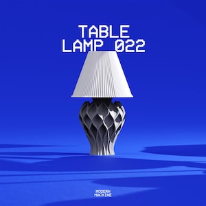 May include: A table lamp with a white pleated conical shade and a dark gray, intricate, lattice-patterned base. The text "TABLE LAMP 022" appears above the lamp, and "MODERN MACHINE" is printed in small white letters at the bottom center.
