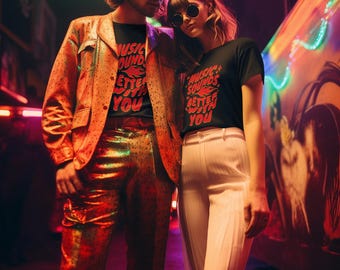 May include: Two people wearing black t-shirts with the text "Music Sounds Better With You" in red and white. The person on the left is wearing a gold jacket and pants. The person on the right is wearing white pants. They are standing in front of a wall with colorful lights.