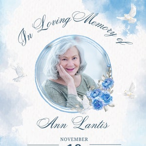 May include: In Loving Memory of Ann Lantis. A memorial card with a photo of a woman in a circle, blue flowers, and white doves. The date of the memorial is November 10th at 8:30 PM. The address is 123 Anywhere St., Any City, ST 12345.