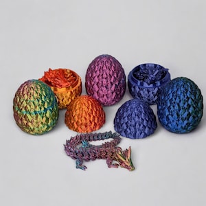 May include: A set of six iridescent dragon egg-shaped containers with a small iridescent dragon figurine. The eggs are in various colours, including purple, blue, green, and orange.