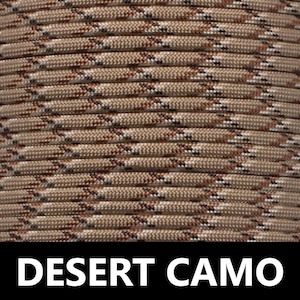 May include: Close-up of a tan, brown, and white paracord with a desert camo pattern. The paracord is woven together in a tight, even pattern.