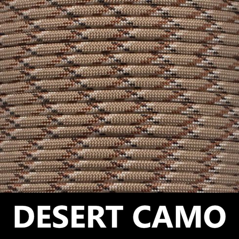 May include: Close-up of a tan, brown, and white paracord with a desert camo pattern. The paracord is woven together in a tight, even pattern.