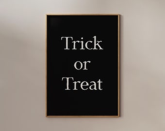 May include: A black framed print with white text that reads "Trick or Treat".