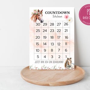Puede incluir: Un calendario de cuenta atrás imprimible para el inicio del curso escolar con una ilustración de un caballo y flores rosas. El calendario tiene números del 30 al 1 y el texto "COUNTDOWN" y "Schulstart".