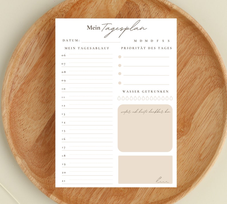 May include: A printable daily planner with a minimalist design. The planner includes sections for daily tasks, priorities, and water intake. The text "Mein Tagesplan" is at the top of the page.