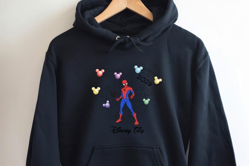 May include: Black hooded sweatshirt with a Spider-Man design in red and blue, encircled by colourful Mickey Mouse head shapes. The text "2020" and "Disney Trip" are also visible.