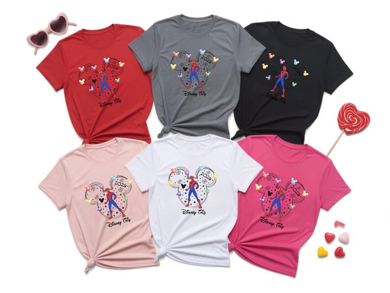 May include: Six t-shirts in red, grey, black, pink, white, and rose. Each shirt features a Mickey Mouse head design with a Spider-Man figure and the text "Disney Trip 2024".