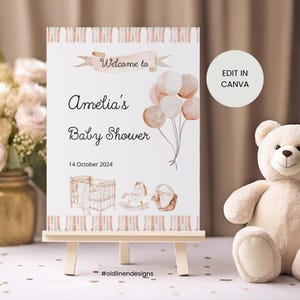 Pode incluir: Um cartaz de boas-vindas para um chá de bebê com um design de aquarela de balões, um berço, um cavalinho de balanço e uma cesta. O cartaz diz "Bem-vindo ao chá de bebê de Amelia" e "14 de outubro de 2024".