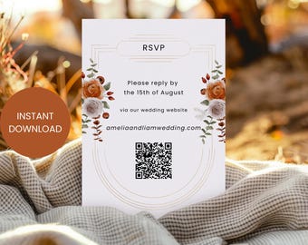 May include: A white RSVP card with a gold border and floral design. The text reads "Please reply by the 15th of August via our wedding website ameliaandliamwedding.com". A QR code is included for easy access to the website. The hashtag #oldlinendesigns is at the bottom of the card.