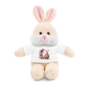 May include: A plush white bunny wearing a white t-shirt with a colourful Easter egg design. The bunny has pink ears and a white face.