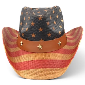 May include: Cowboy hat with a patriotic design. The hat features a black crown adorned with gold stars and a brown leather band with star-shaped studs. The brim displays red and tan stripes.