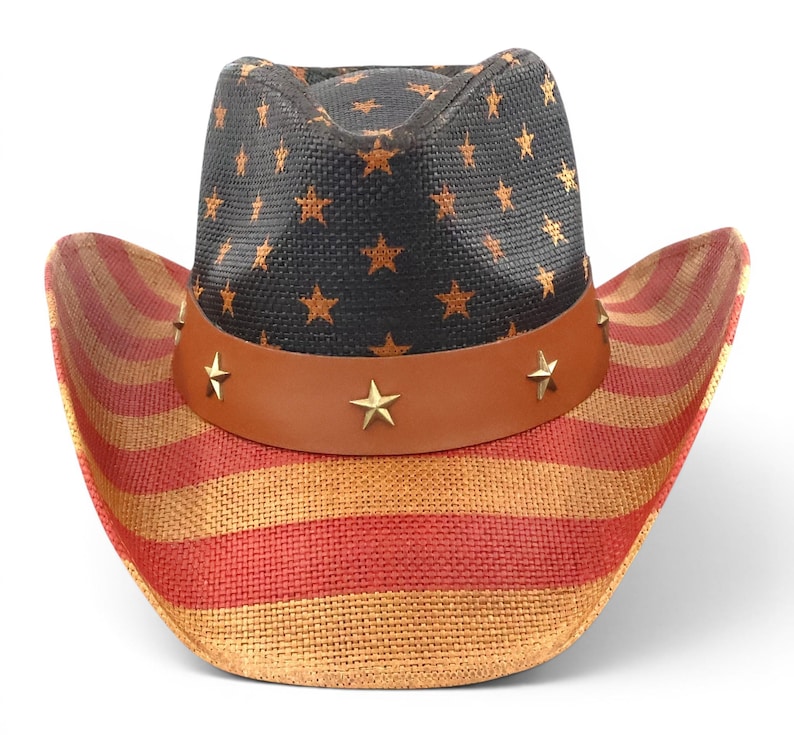 May include: Cowboy hat with a patriotic design. The hat features a black crown adorned with gold stars and a brown leather band with star-shaped studs. The brim displays red and tan stripes.
