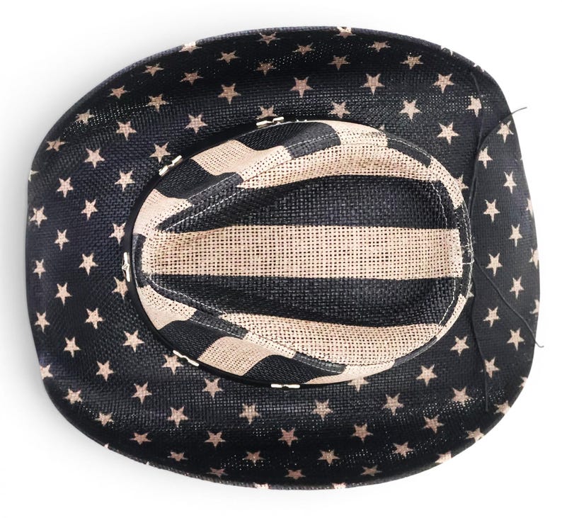 May include: A black cowboy hat with a star pattern on the brim and a striped pattern on the crown. The hat is made of woven material and has a classic western design.