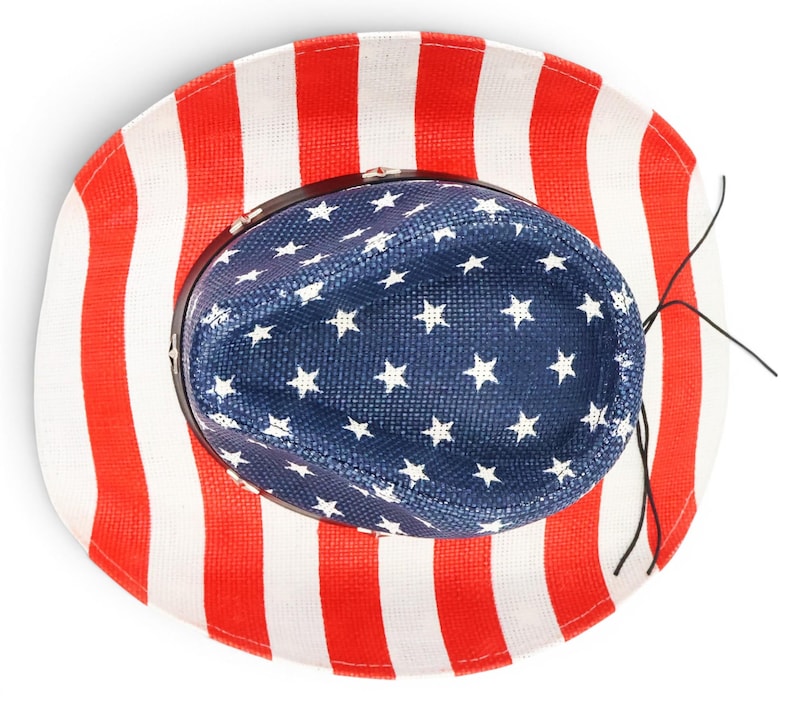 May include: A patriotic cowboy hat with a red and white striped brim and a blue crown adorned with white stars. The hat is designed with the colors of the American flag.